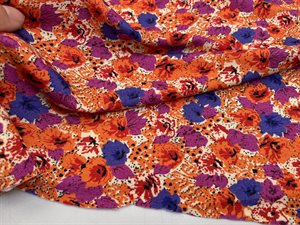 Viscosejersey - blomstret i matte violette / orange toner